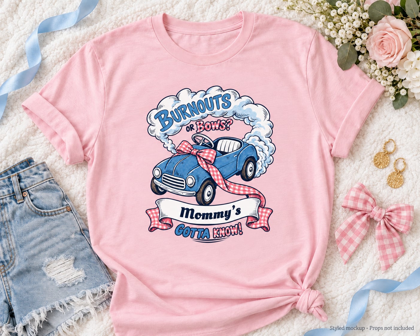 Styled mockup of the personalized Mommy's Burnouts or Bows shirt in Light Pink with flowers, gingham bow and blue ribbon. Props not included.